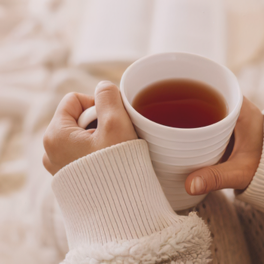 Hands holding a warm cup of tea